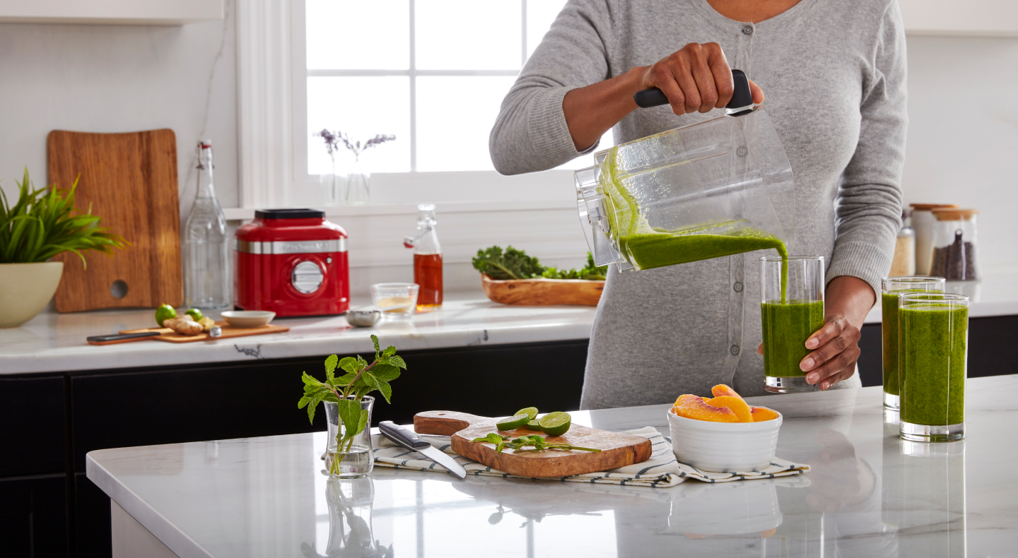 Person pouring a shake into a glass Person pouring a shake into a glass