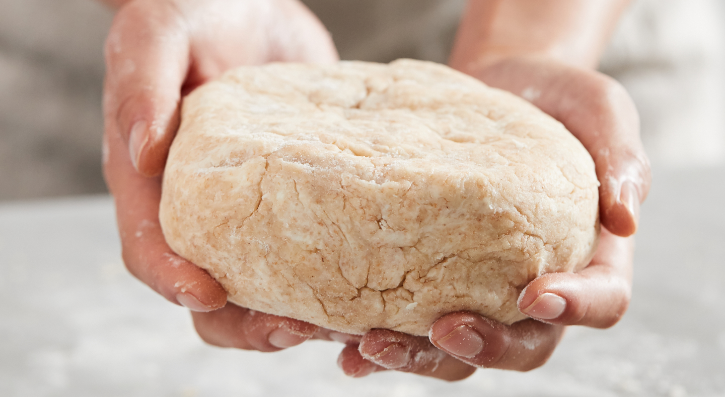 Kneaded dough in a person's hands Kneaded dough in a person's hands