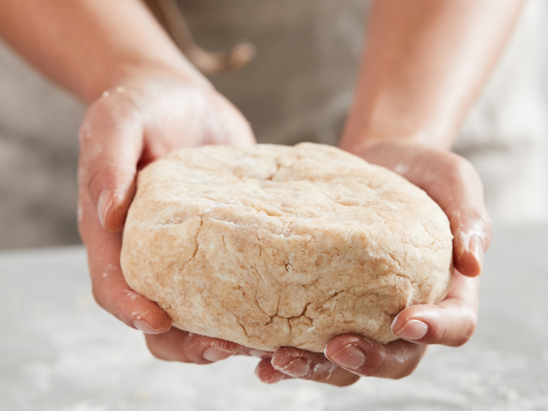Kneaded dough in a person's hands Kneaded dough in a person's hands