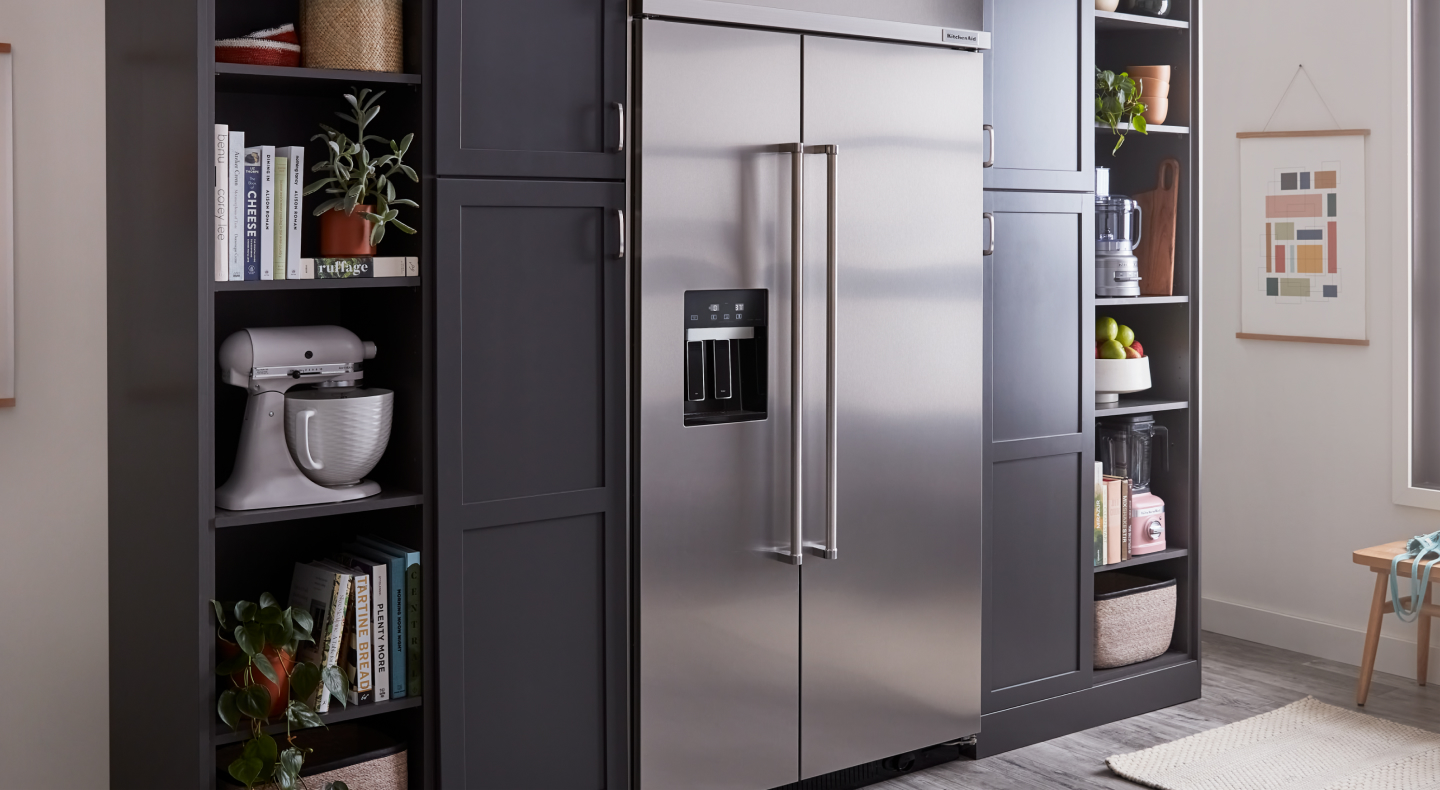 A stainless steel KitchenAid® side-by-side fridge in a kitchen A stainless steel KitchenAid® side-by-side fridge in a kitchen