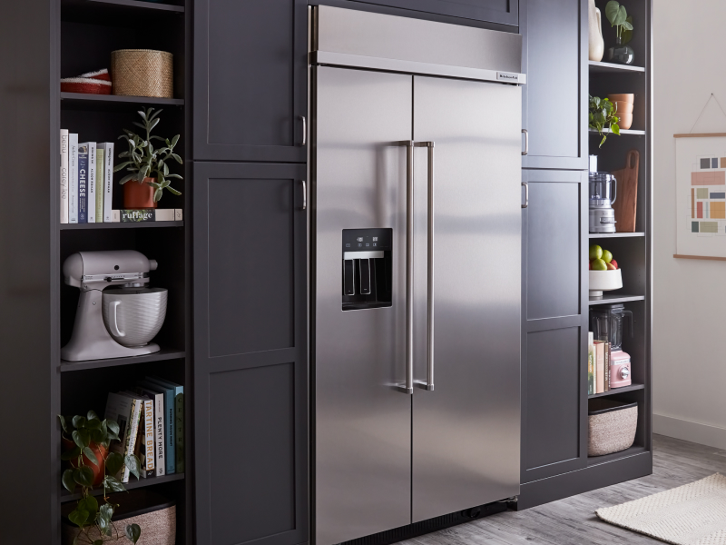 A stainless steel KitchenAid® side-by-side fridge in a kitchen A stainless steel KitchenAid® side-by-side fridge in a kitchen