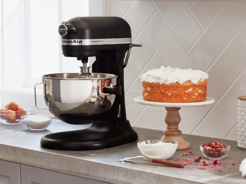 A black KitchenAid® stand mixer next to a cake A black KitchenAid® stand mixer next to a cake