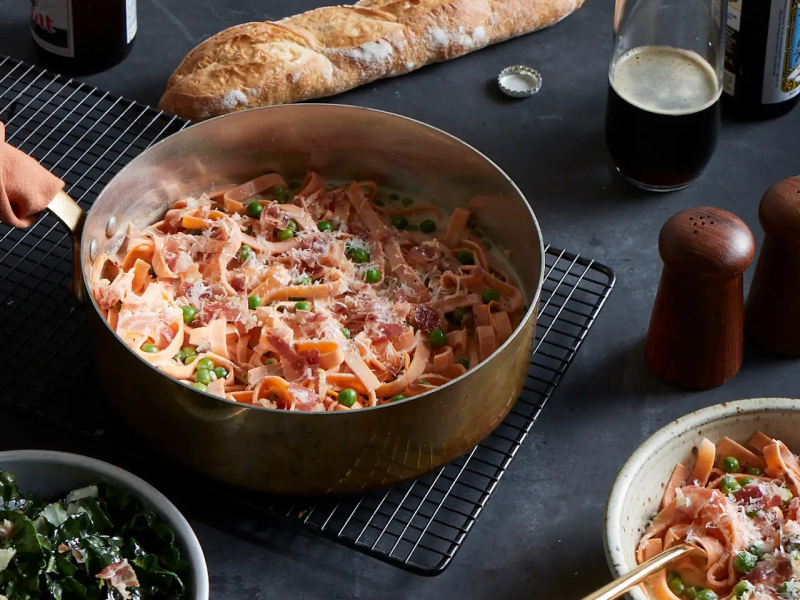 Bowl of pasta with red sauce and peas