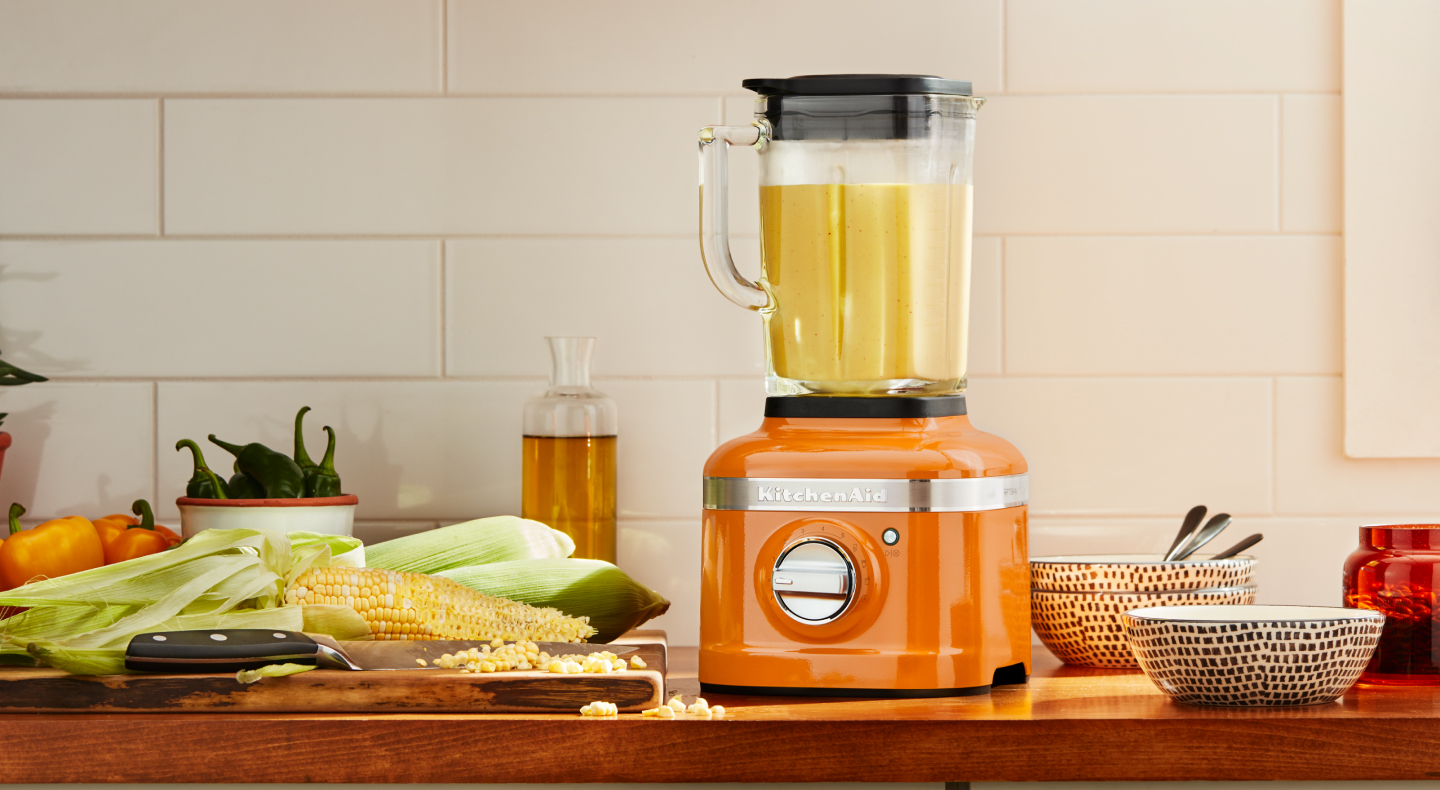 Orange KitchenAid® blender next to corn on the cob Orange KitchenAid® blender next to corn on the cob