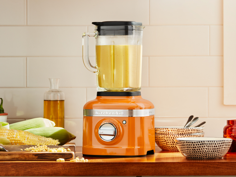 Orange KitchenAid® blender next to corn on the cob Orange KitchenAid® blender next to corn on the cob