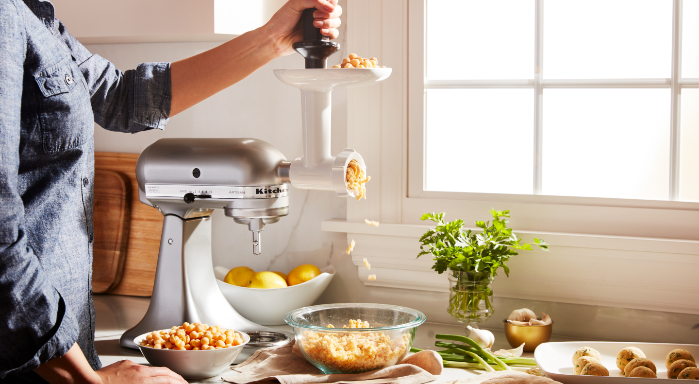 Vegetarian “meatball” mixture coming out of KitchenAid® food grinder attachment Vegetarian “meatball” mixture coming out of KitchenAid® food grinder attachment
