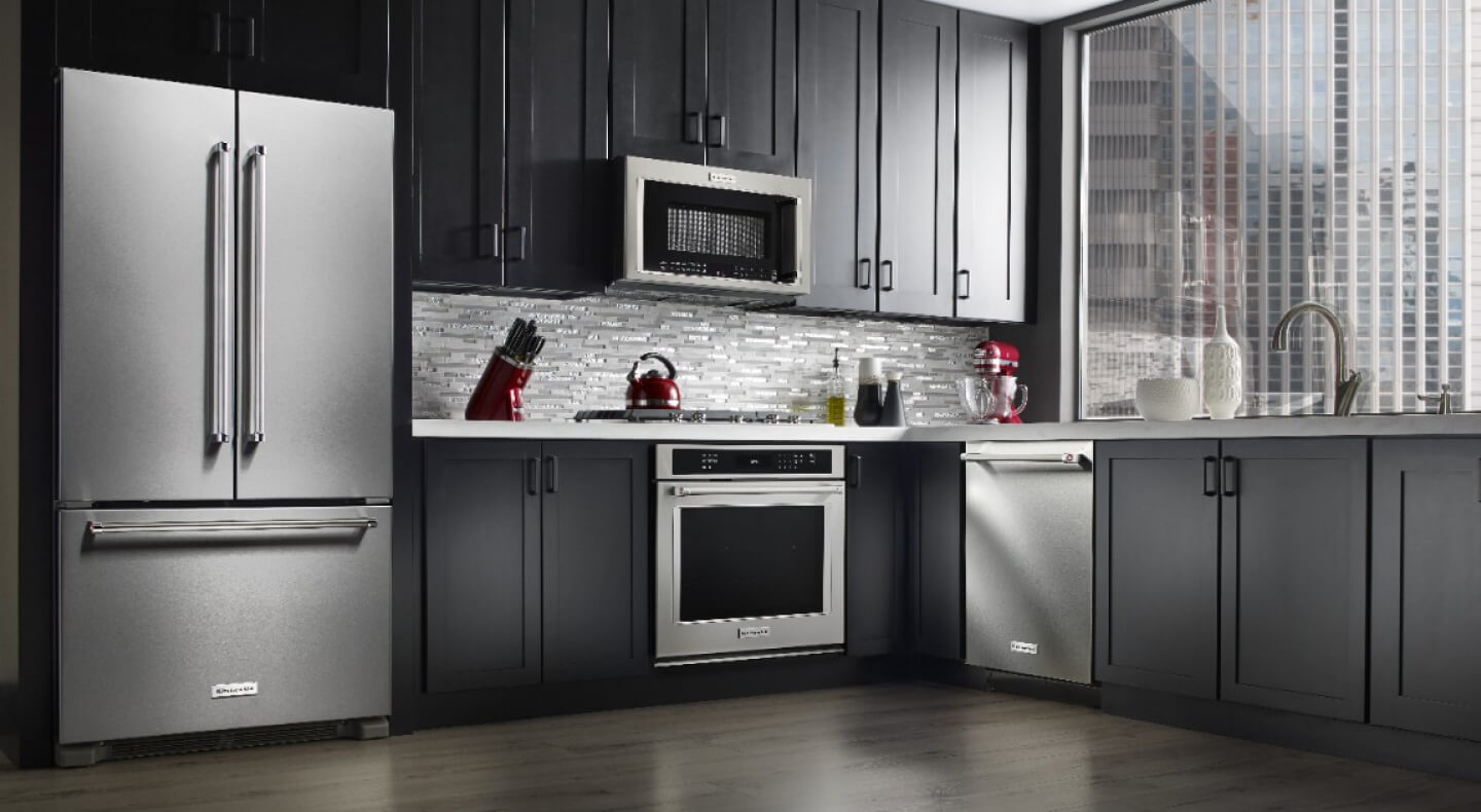 Stainless steel KitchenAid® appliances in a sleek, modern kitchen