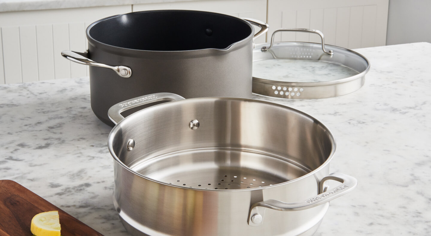 A pot with a metal steaming basket A pot with a metal steaming basket