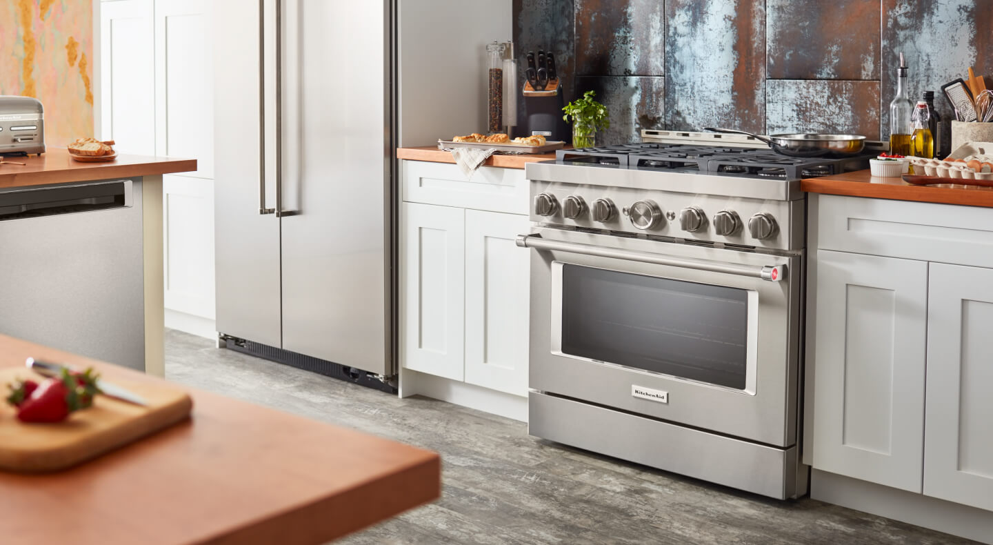 A kitchen with a KitchenAid® commercial gas range