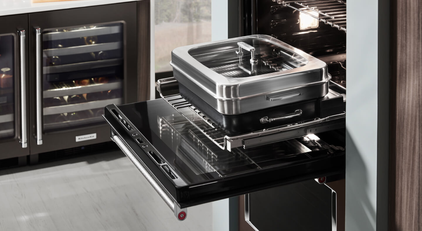 An oven with cookware used for steaming An oven with cookware used for steaming