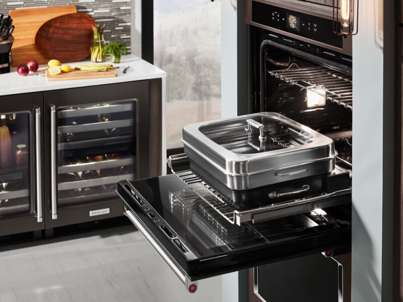 An oven with cookware used for steaming An oven with cookware used for steaming