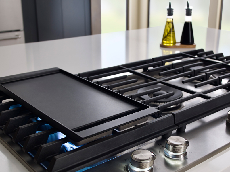 A griddle preheating on a gas stove A griddle preheating on a gas stove