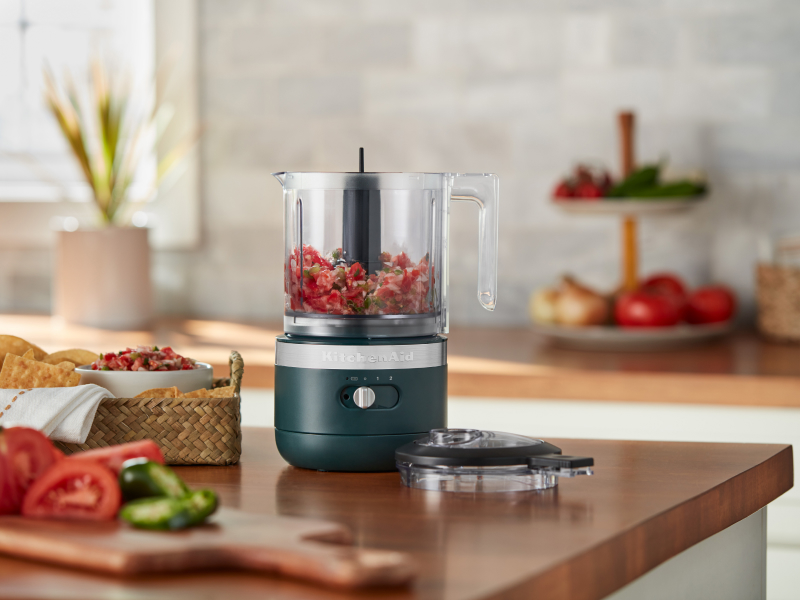 Gray food chopper filled with prepared Pico de Gallo