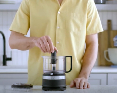 Person assembling black food chopper