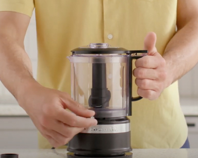 Person adjusting controls on food chopper