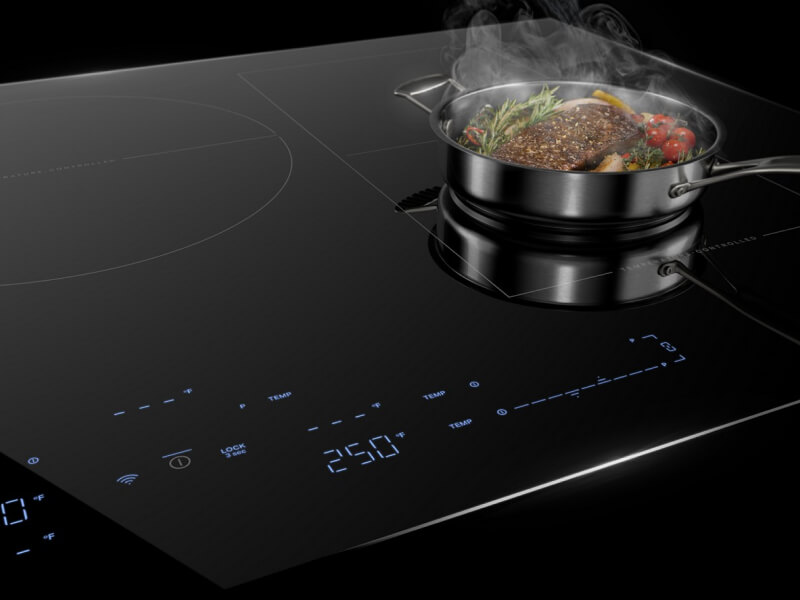 An induction cooktop with steak in a pan on it