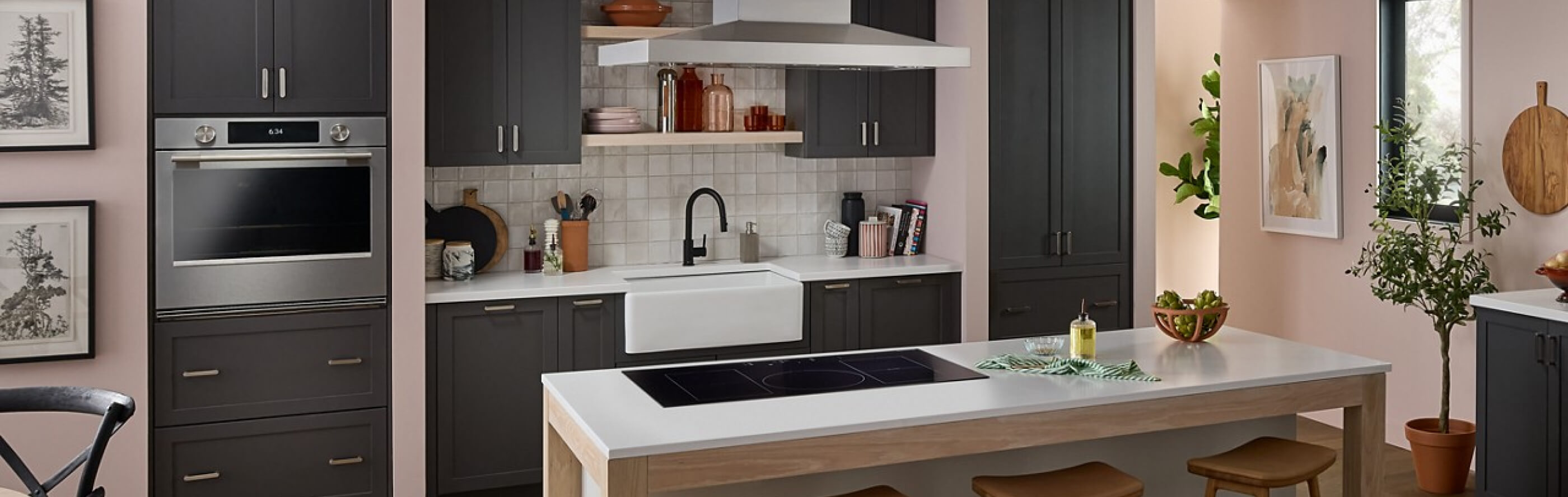 A neutral-toned kitchen with an induction cooktop set into an island