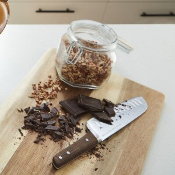 Chopped chocolate and nuts on a wooden cutting board