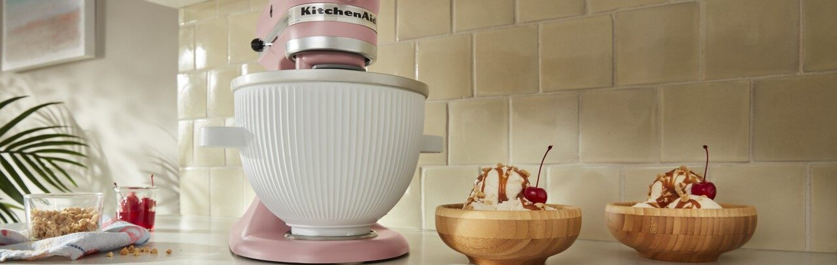 Pink KitchenAid® stand mixer next to two ice cream sundaes