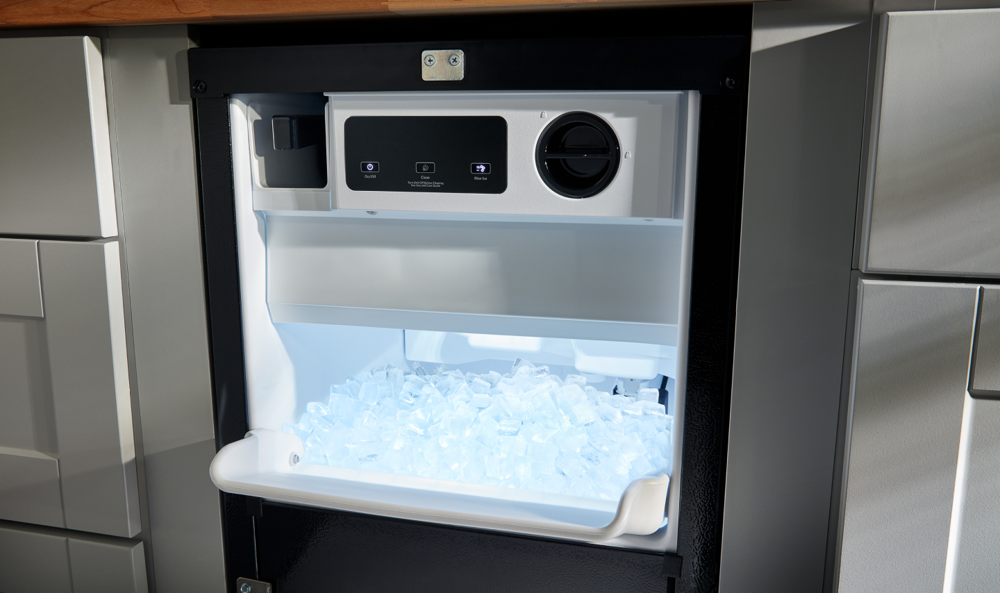 An open ice maker drawer An open ice maker drawer