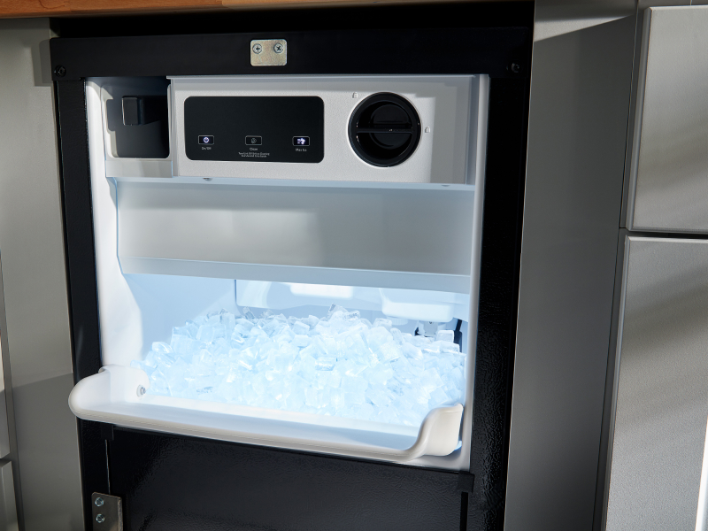 An open ice maker drawer An open ice maker drawer