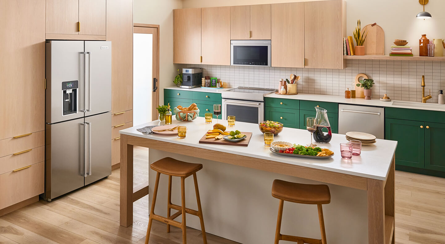 A bright kitchen island with veggie platters and wine on it A bright kitchen island with veggie platters and wine on it