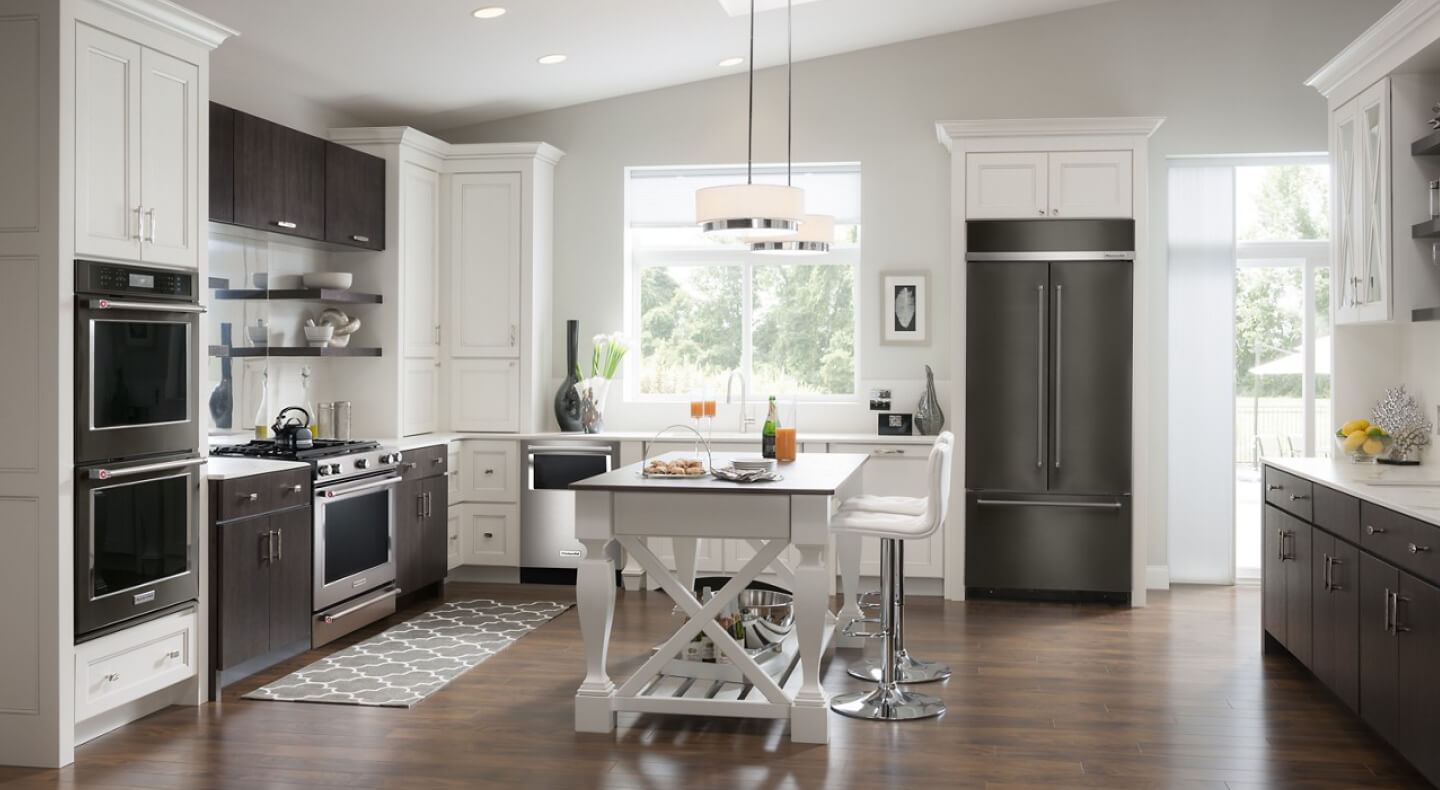 A kitchen with an island table and stool seating A kitchen with an island table and stool seating