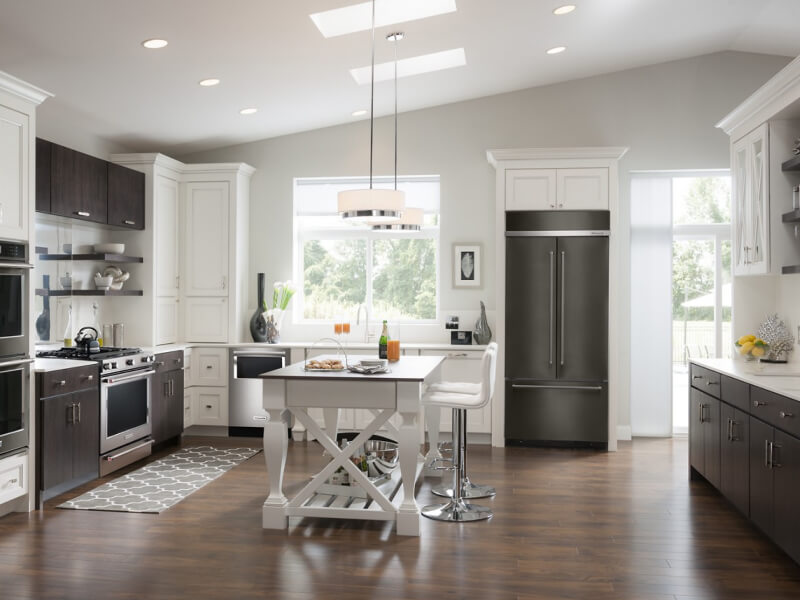 A kitchen with an island table and stool seating A kitchen with an island table and stool seating