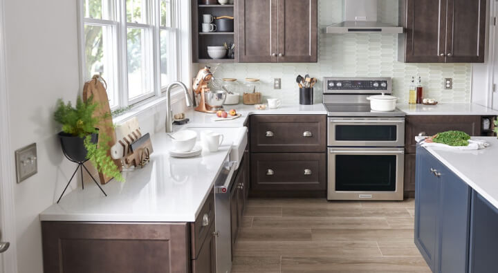 A kitchen with stainless steel appliances and white countertops A kitchen with stainless steel appliances and white countertops