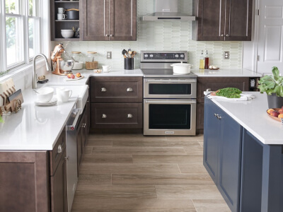 A kitchen with stainless steel appliances and white countertops A kitchen with stainless steel appliances and white countertops