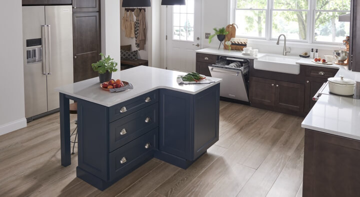 A kitchen with a large island and stainless steel appliances A kitchen with a large island and stainless steel appliances