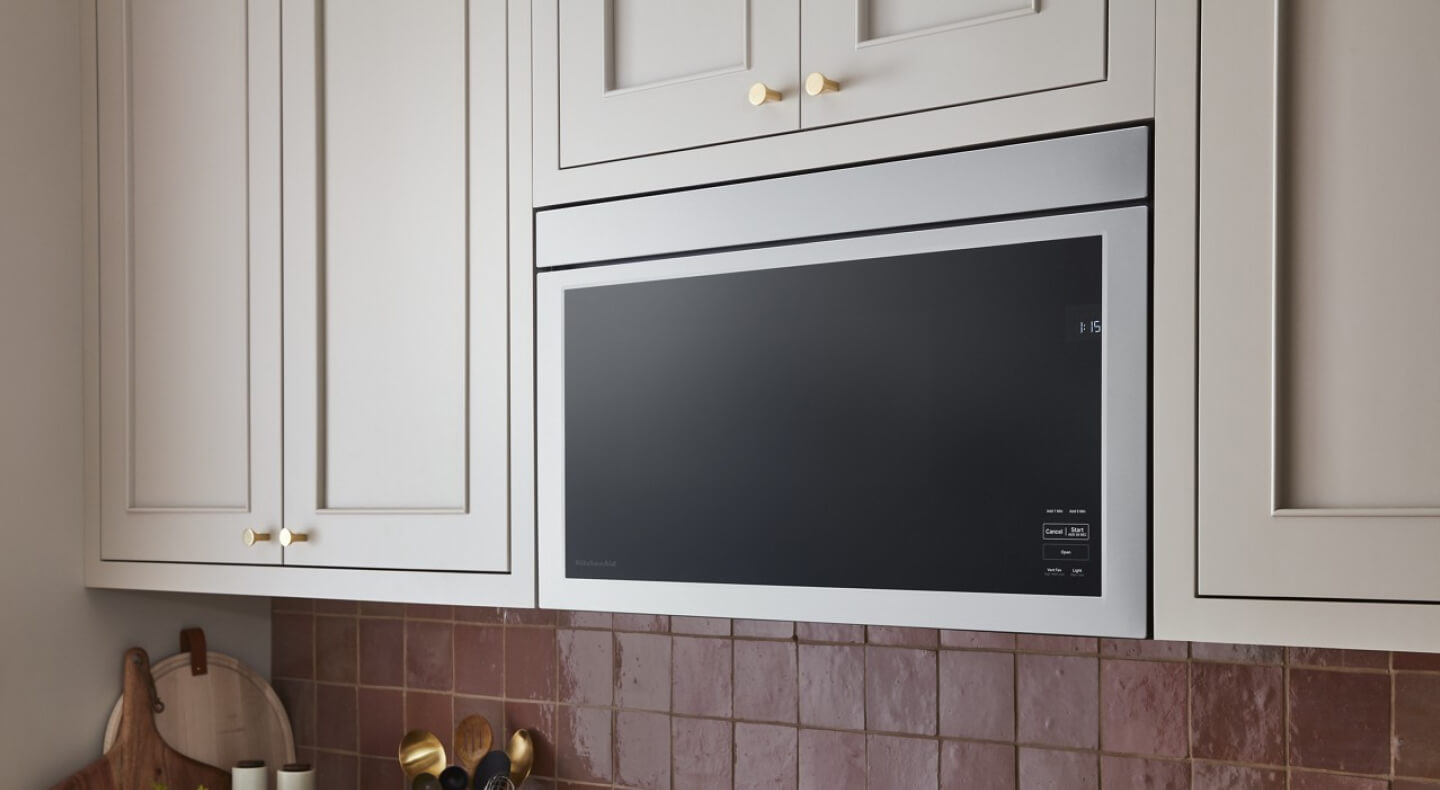 Flush over-the-range microwave against white cabinetry
