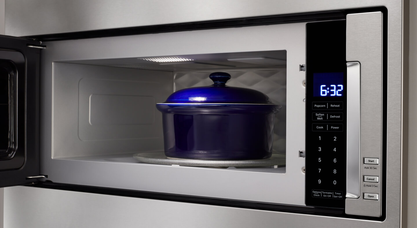 Blue dish inside microwave cavity with door open Blue dish inside microwave cavity with door open
