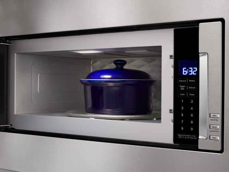 Blue dish inside microwave cavity with door open Blue dish inside microwave cavity with door open