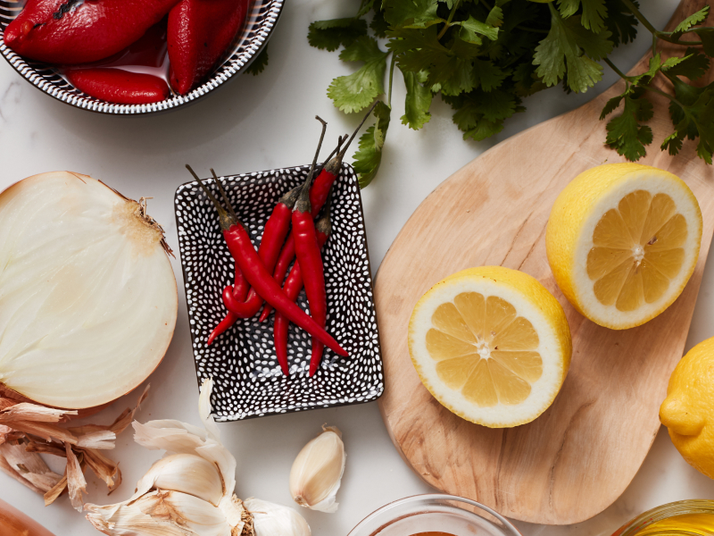 Onions, Chili peppers and lemon on table