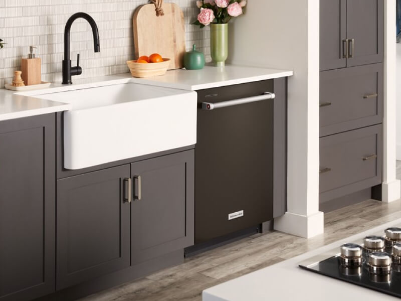 Flush dishwasher installed next to a farmhouse sink