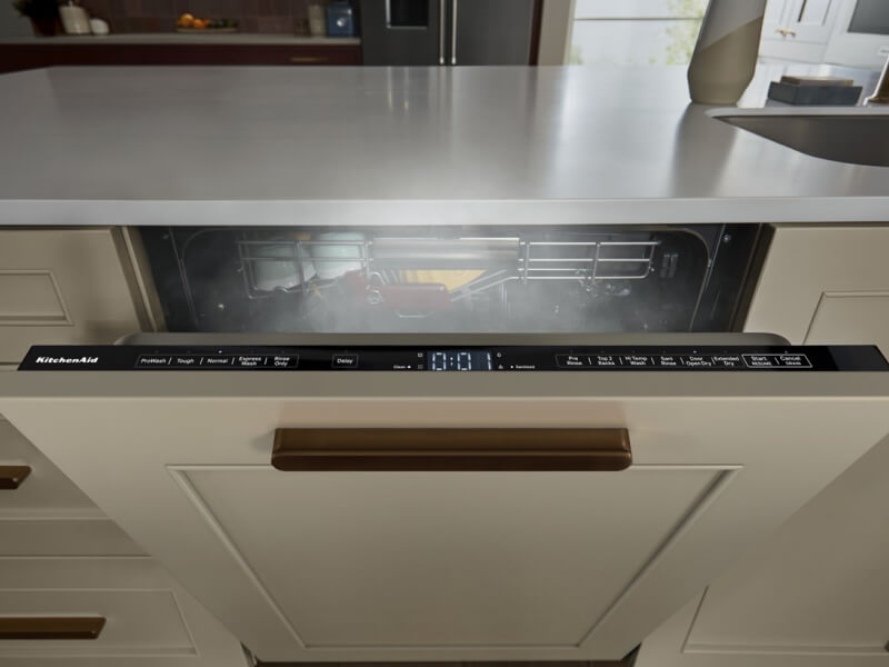 Opened panel-ready dishwasher air drying dishes