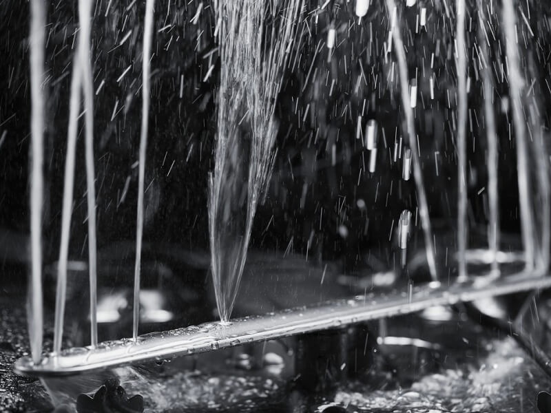 A dishwasher spray arm spewing water