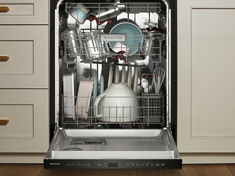 Dishwasher open to reveal dishes inside