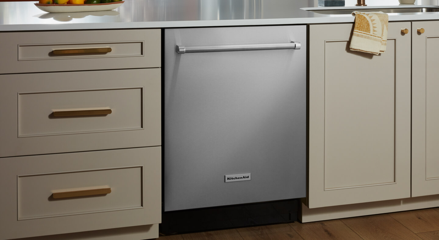 KitchenAid® dishwasher set in cream-colored cabinetry