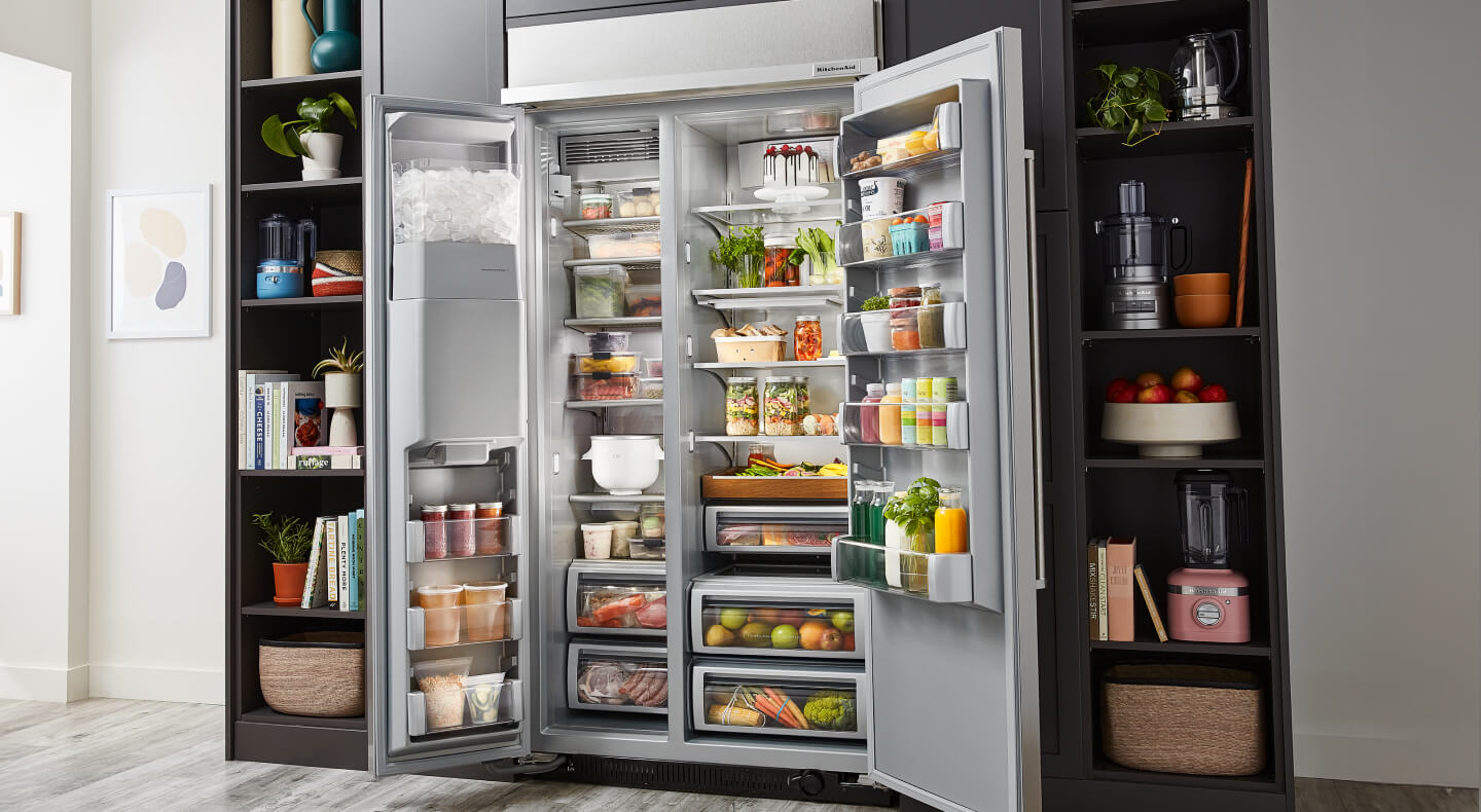An open side-by-side refrigerator, full of colorful food items An open side-by-side refrigerator, full of colorful food items