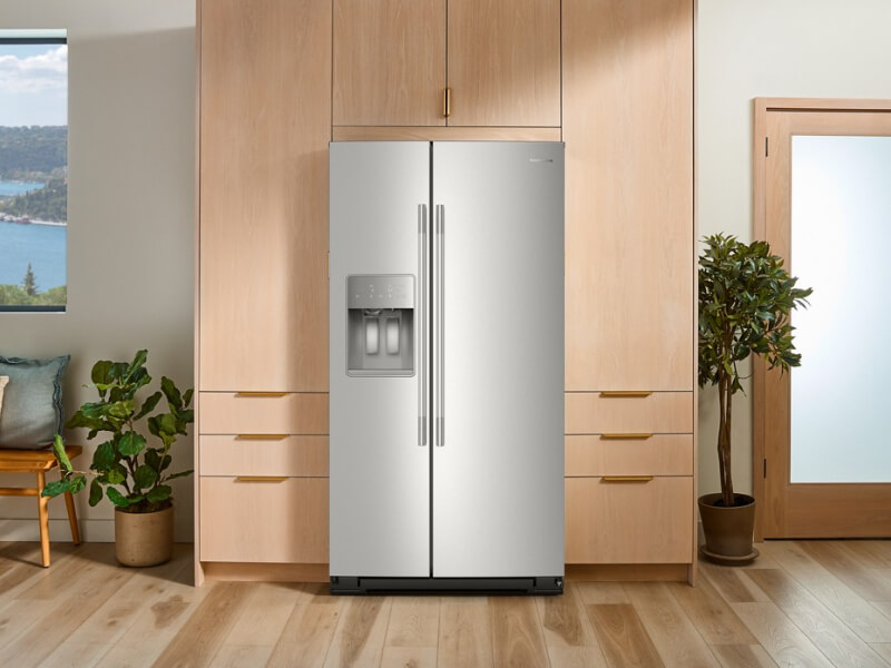 A stainless steel side-by-side refrigerator surrounded by pale wood cabinetry A stainless steel side-by-side refrigerator surrounded by pale wood cabinetry