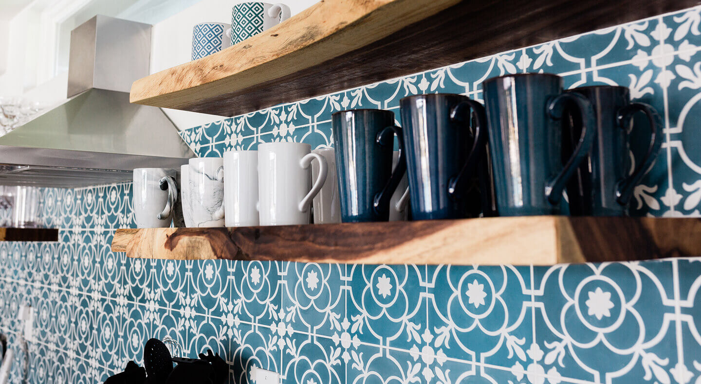 Mugs on floating wood shelves installed on a patterned wall Mugs on floating wood shelves installed on a patterned wall