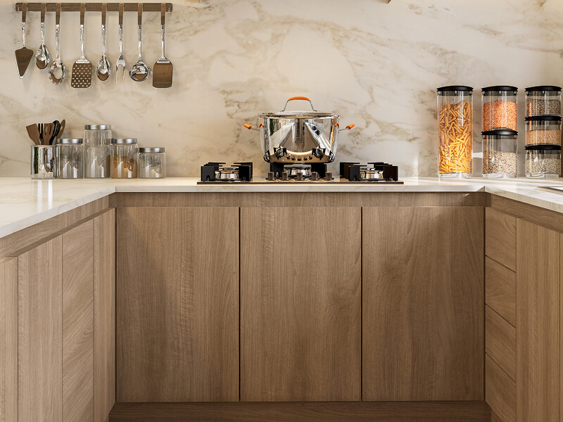Light brown cabinetry with no handles on cabinets or drawers Light brown cabinetry with no handles on cabinets or drawers