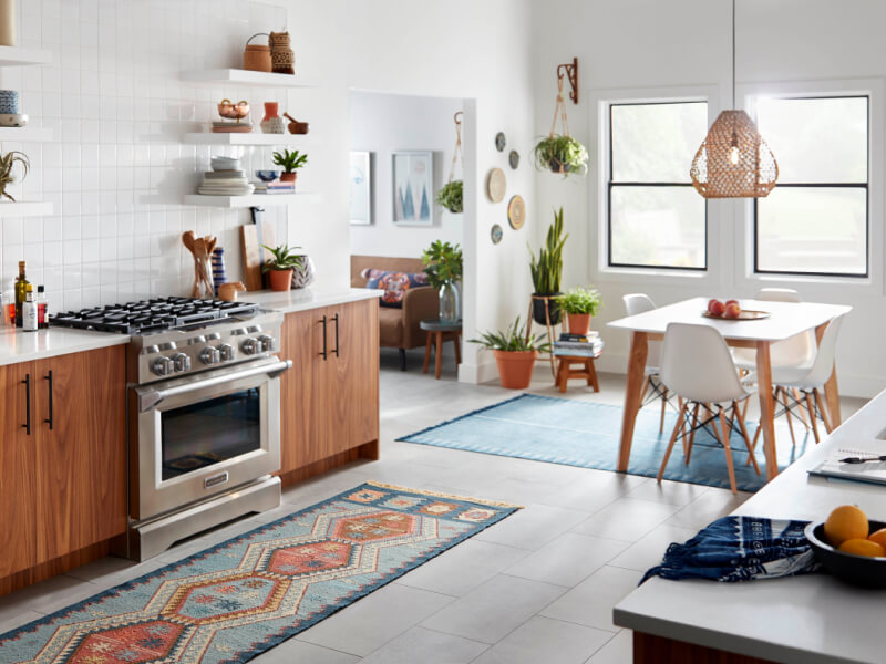 Open kitchen with a commercial-style gas range by KitchenAid brand Open kitchen with a commercial-style gas range by KitchenAid brand