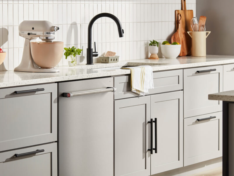 KitchenAid® flush dishwasher among light gray kitchen cabinetry KitchenAid® flush dishwasher among light gray kitchen cabinetry