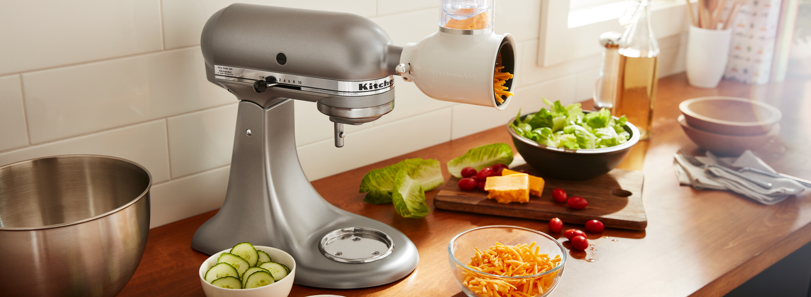 Silver KitchenAid® stand mixer with Fresh Prep Slicer/Shredder Attachment