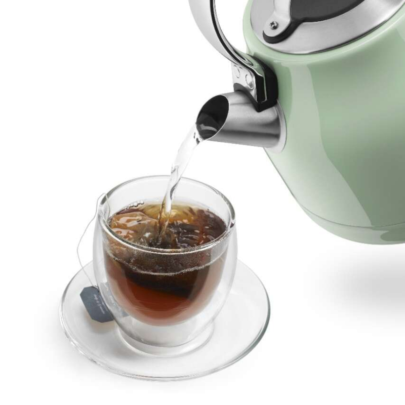 Water pouring from an electric kettle into a mug of tea