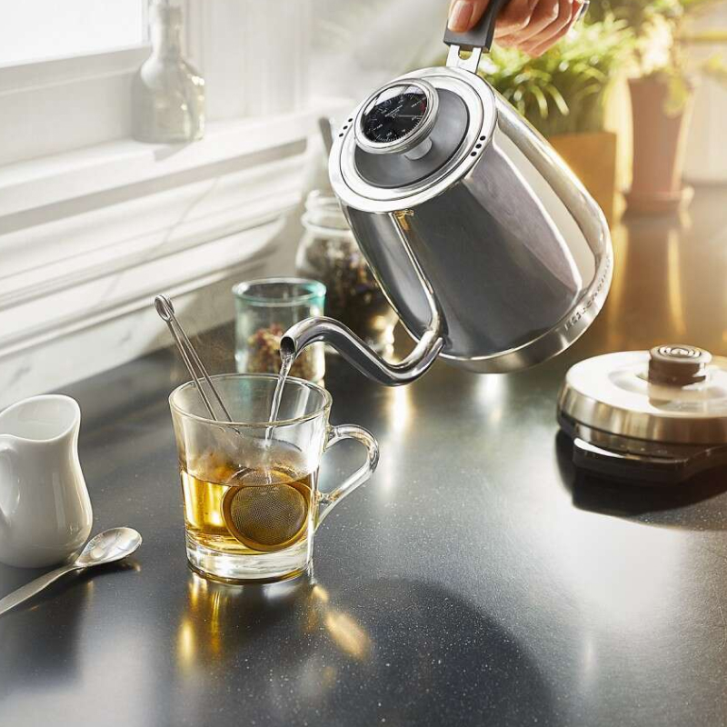 Gooseneck kettle pouring water into a mug of tea