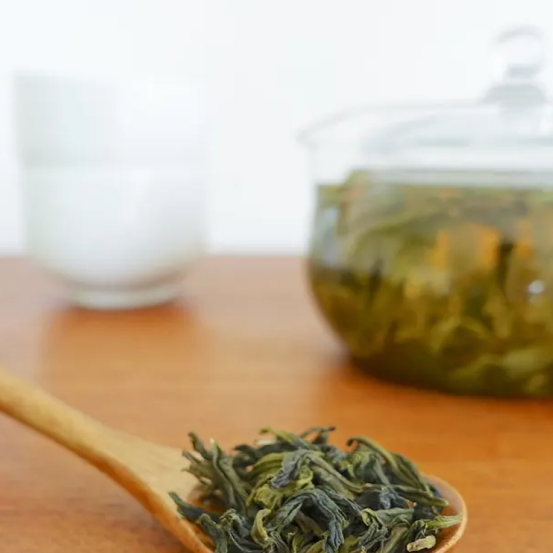 Wooden spoon full of loose leaf tea